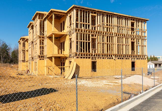 construction zone secured with a temporary fence, marked with warning signs in Henderson